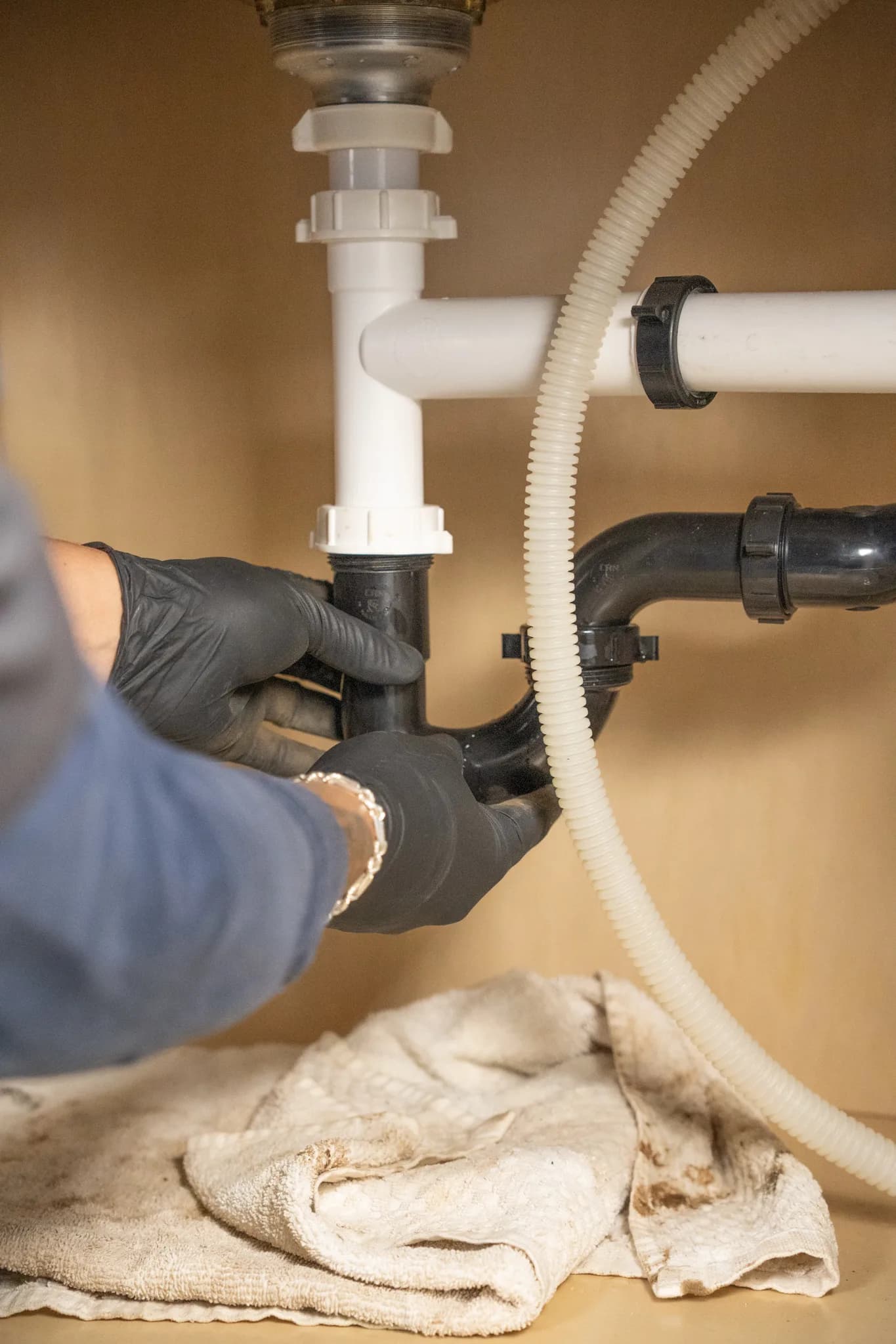 Close-up of a sink drain and P-trap being serviced by Warriors Plumbing & Rooter in Phoenix